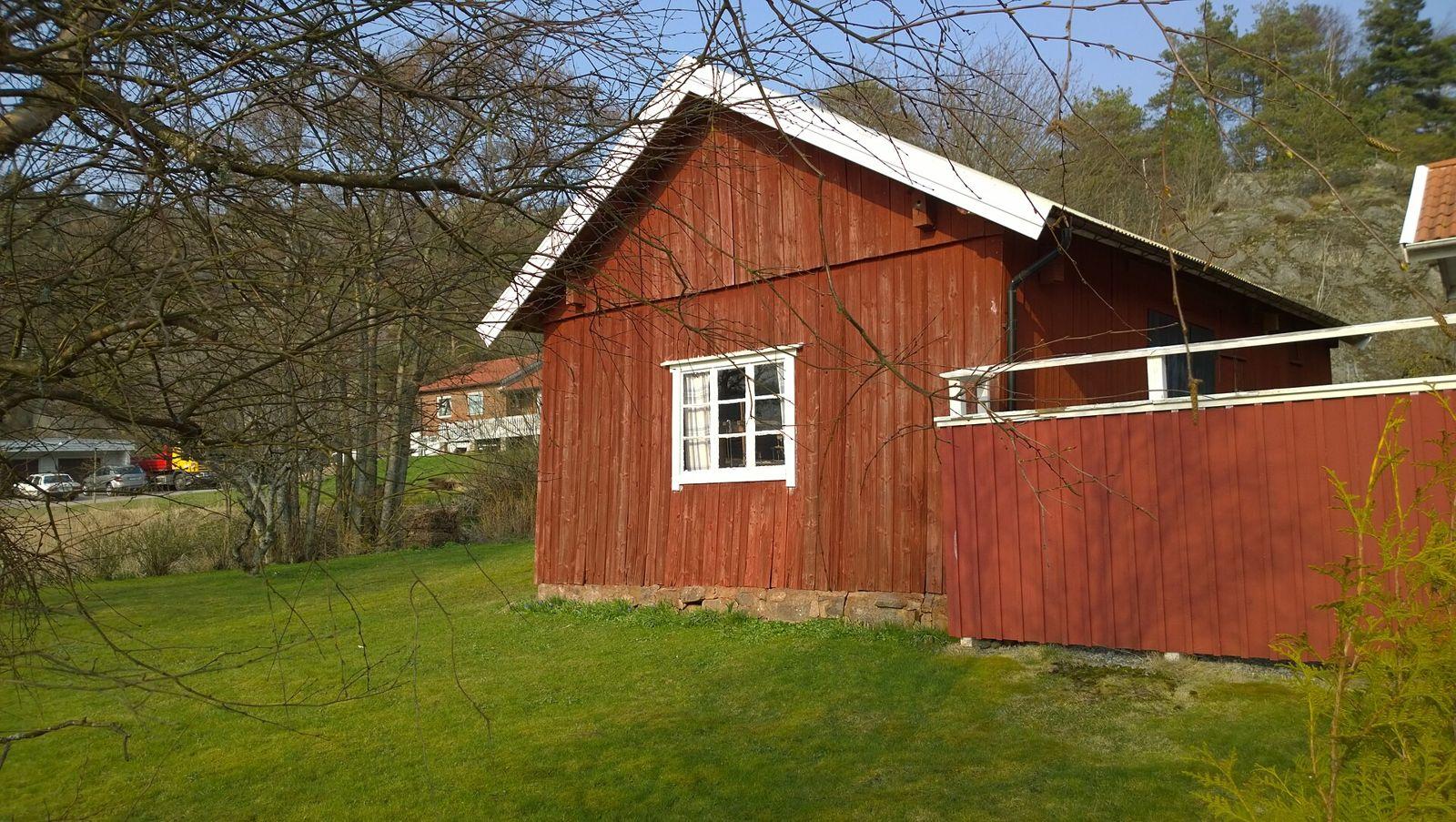 Wood-sided older house with a raised crawl space foundation on a green lawn