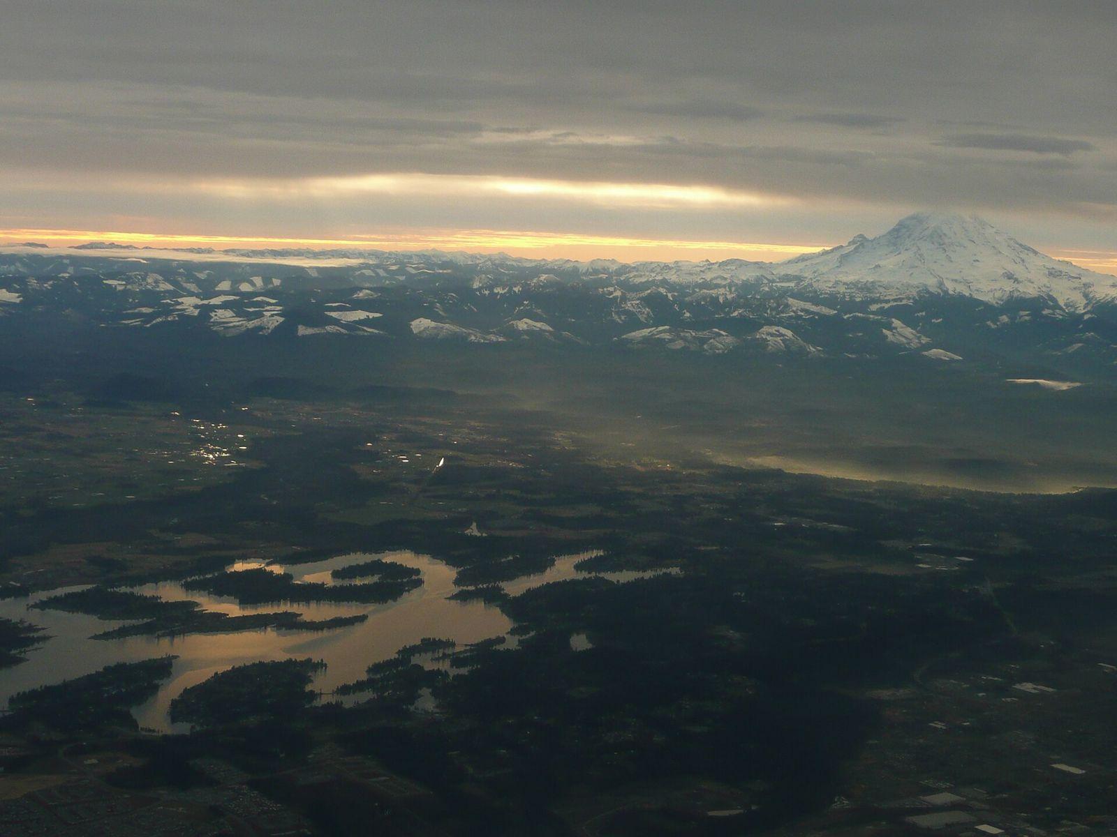 Aerial view of Lake Tapps and the surrounding plateau with Mount Rainier rising above the clouds